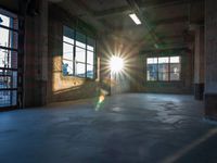 a sun shines brightly through the window on an abandoned warehouse building interior, as seen from inside