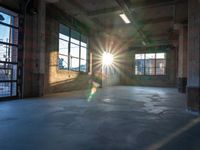 a sun shines brightly through the window on an abandoned warehouse building interior, as seen from inside