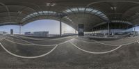 a full view of an airport with two airplane gates and buildings in the background, as well as an upside down view of the building