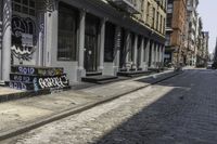 a sidewalk with some graffiti and a sign on it that says coffee and skateboards