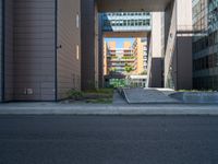 a road through which is a large modern building with an awning over it's entrance