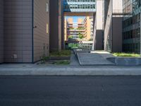 a road through which is a large modern building with an awning over it's entrance