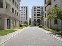 a walkway leads through two high rise apartment buildings in an urban setting outside a city