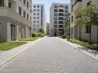 a walkway leads through two high rise apartment buildings in an urban setting outside a city