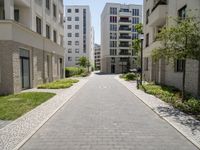 a walkway leads through two high rise apartment buildings in an urban setting outside a city