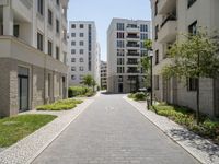 a walkway leads through two high rise apartment buildings in an urban setting outside a city