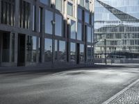 a road in front of buildings with a bike rack and a street light on the ground