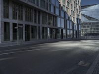 a road in front of buildings with a bike rack and a street light on the ground