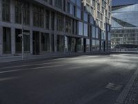 a road in front of buildings with a bike rack and a street light on the ground