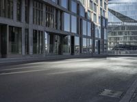 a road in front of buildings with a bike rack and a street light on the ground