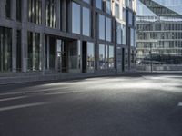 a road in front of buildings with a bike rack and a street light on the ground