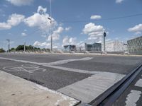 a bicycle lane that looks empty under the blue sky with clouds and bright blue skies