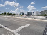 a bicycle lane that looks empty under the blue sky with clouds and bright blue skies