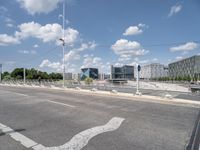 a bicycle lane that looks empty under the blue sky with clouds and bright blue skies