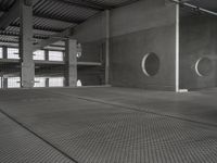 an empty garage with several circular holes in the walls and flooring that leads to a large area