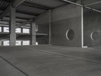 an empty garage with several circular holes in the walls and flooring that leads to a large area