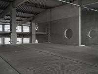 an empty garage with several circular holes in the walls and flooring that leads to a large area