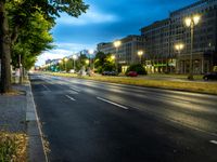 a car passing the stop light on an empty street, at twilight or dawn in a european city