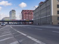 an intersection with a bridge and cars going over it and another highway in the background