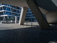 the building has several different angles on it, in varying colors and shapes with brick and concrete floors