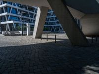 the building has several different angles on it, in varying colors and shapes with brick and concrete floors