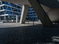 the building has several different angles on it, in varying colors and shapes with brick and concrete floors