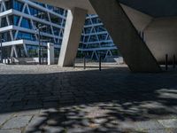 the building has several different angles on it, in varying colors and shapes with brick and concrete floors