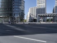 city buildings next to a big long roadway in the middle of an urban setting with no traffic