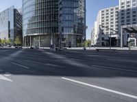 city buildings next to a big long roadway in the middle of an urban setting with no traffic