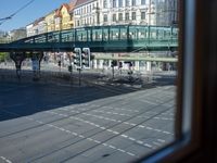 a street view is seen through a window at an intersection with buildings and cars passing by