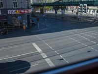 a street view is seen through a window at an intersection with buildings and cars passing by