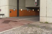 a empty parking garage next to an overpass with doors on it and a stoplight