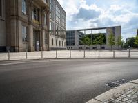 a wide open space of concrete surrounded by a lot of windows and a wire fence