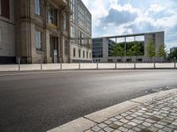 a wide open space of concrete surrounded by a lot of windows and a wire fence