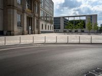 a wide open space of concrete surrounded by a lot of windows and a wire fence