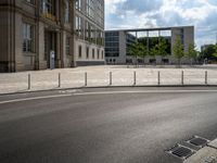 a wide open space of concrete surrounded by a lot of windows and a wire fence