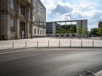 a wide open space of concrete surrounded by a lot of windows and a wire fence