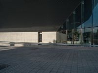 a white building next to a pool in a courtyard area with a walkway leading into it