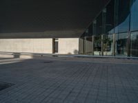 a white building next to a pool in a courtyard area with a walkway leading into it