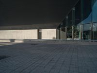 a white building next to a pool in a courtyard area with a walkway leading into it