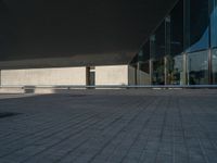 a white building next to a pool in a courtyard area with a walkway leading into it