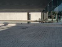 a white building next to a pool in a courtyard area with a walkway leading into it