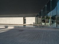 a white building next to a pool in a courtyard area with a walkway leading into it