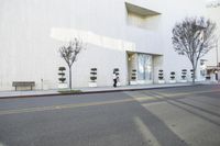 a fire hydrant on the side of a building with many seats to sit in