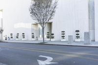 a fire hydrant on the side of a building with many seats to sit in