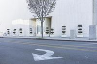 a fire hydrant on the side of a building with many seats to sit in