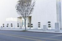 a fire hydrant on the side of a building with many seats to sit in