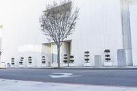 a fire hydrant on the side of a building with many seats to sit in