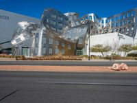 a building that has some kind of sculpture on the side of the street near the street