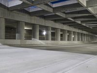 an empty parking garage with no people in it at night time time with only one stop sign